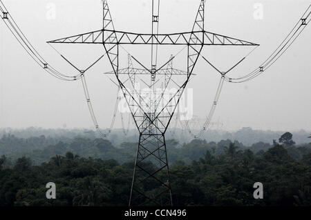 CISEENG, BOGOR, INDONESIA - AUGUST 16, 2004  Views of power lines and towers, around rural and village areas, in south Jakarta, and Bogor, West Java.   Poor people have left Jakarta due to high cost of land and have settled on land which is free - underneath power lines and structures, risking their Stock Photo