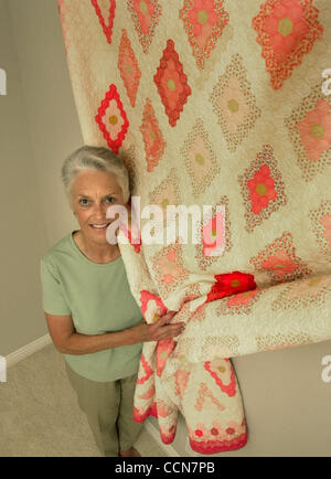 Linda Jones holds one of her many quilts in her quilt collection in Danville, Calif., on Tuesday, August 24, 2004. Starting on September 1, 2004, some of Jones's rare quilts will be on display at the Museum of the San Ramon Valley. (Contra Costa Times/Doug Duran) Stock Photo