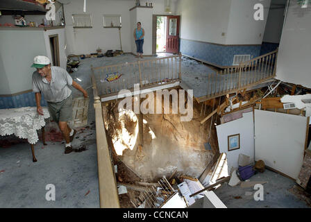 091804 met ivan--Pensacola--Jerry Flannagan, walks through his heavily damaged and partially collapsed home on Scenic hwy that was destroyed by Hurricane Ivan. His home of 14 years was destroyed . He was removing what was left into a U-Haul trailer. Staff photo by Greg Lovett Stock Photo