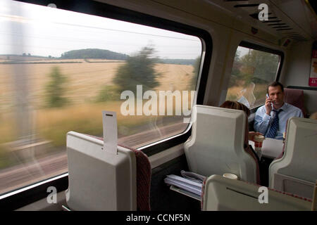 Oct 05, 2004; London, UK; Travellers and passengers on the train from London to Leeds enjoy reading books as the scenery of fields and trees flies by. Public transport in the UK is relied on by millions. London transport system and British Rail help commuters get to work everyday. Stock Photo