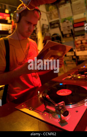 Oct 05, 2004; Leeds, UK; A DJ and record collector try out some new LP's, 45's and 78's on decks in a record store. Rare music on vinyl is collectible and becoming harder to find. Stock Photo