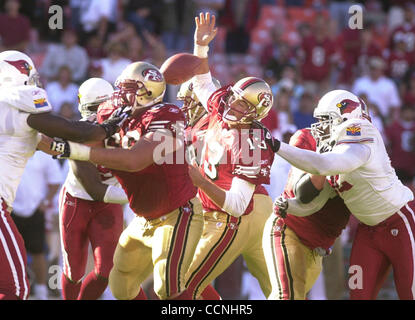 San Francisco Forty Niners quarterback Tim Rattay feels the pressure of St.  Louis Rams Damione Lewis, #92 and Leonard Littlel in the 2nd quarter of  their game at Monster Park in San