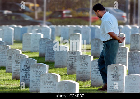 For most of the cemetery workers here at Golden Gate National Cemetery, burials of veterans is an honor.They settled 600 vets and family members into the ground last year alone. Following a full military honors burial for Marine Erick Hodges Friday, November 19, 2004, a cemetery workers waits a resp Stock Photo