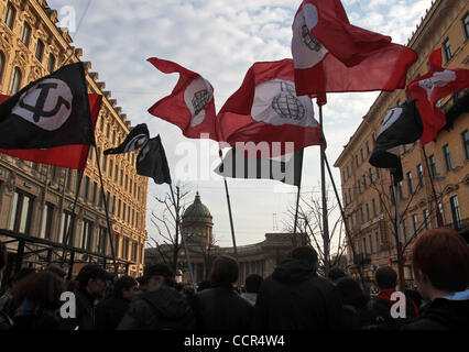 Russian nationalists of the forbidden National Bolshevik party (NBP)with their flags and symbolics at a protest rally in St.Petersburg. Russian radical nationalists protested against NATO . The rally was held under nationalistic slogan of : `Russia Above All, All the Rest is Nothing` (this slogan is Stock Photo