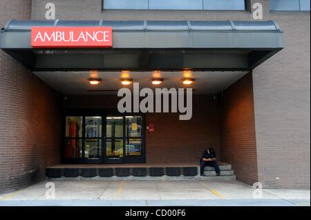 Apr 09, 2010 - Manhattan, New York, USA - 14 year veteran Paramedic Eddie Moore sits in the empty ambulance bay following the first half of a double-shift, he bussed an injured police officer to St. Vincent's at 9:57 a.m. As of 10 a.m. this morning the Fire Department has stopped sending ambulances  Stock Photo