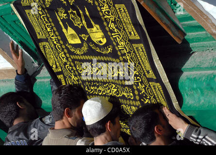 Kashmiri Muslims  devotees raise their hand as the pray outside the shrine of Sufi Saint Syed Abdul Qadir Jilani, during the saint's Urs or, yearly commemoration in Srinagar, India, Friday, April 18, 2008. Thousands of devotees offered prayers on the annual festival at the shrine of Jilani, whose to Stock Photo