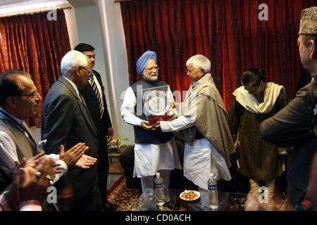 Indian Prime Minister Manmohan Singh being presented by momentum by Lalu Prasad Yadav (R), India's Railways minister after  flagging off Kashmir's first-ever train in Srinagar-Summer Capital of Indian Kashmir October 11, 2008. Singh on Saturday flagged off the first ever train service in Kashmir whe Stock Photo