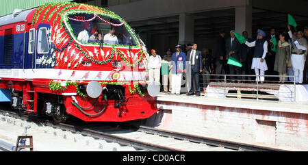 Indian Prime Minister Manmohan Singh (wearing turban), Sonia Gandhi (C), chief of India's ruling Congress Party and Lalu Prasad Yadav (R), India's Railways minister  flagging off Kashmir's first-ever train in Srinagar-Summer Capital of Indian Kashmir October 11, 2008. Singh on Saturday flagged off t Stock Photo