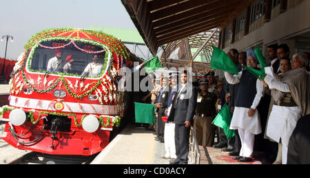 Indian Prime Minister Manmohan Singh (wearing turban), Sonia Gandhi (C), chief of India's ruling Congress Party and Lalu Prasad Yadav (R), Indi's Railways minister wave after flagging off Kashmir's first-ever train in Srinagar-Summer Capital of Indian Kashmir October 11, 2008. Singh on Saturday flag Stock Photo