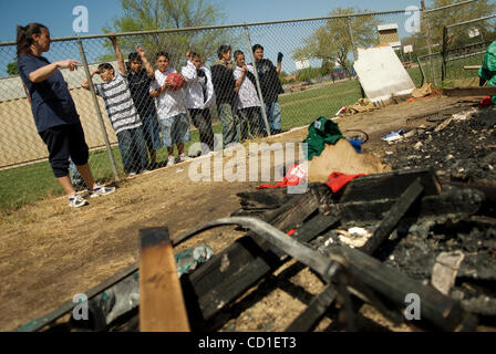 Michelle Kile, a board member for Parkway Little League, left, explains to curious Charles Mack Elementary School students about the fire that damaged the little league's snack shop near their playground March 25, 2008. .  Vandals set fire to the Porta-potties, Sunday, which then burned the equipmen Stock Photo