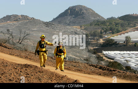 October 14, 2008, Oceanside, CA, USA East of  Camp Pendleton's San Luis Rey Gate two CalFire personnel walk along the large firebreak between the base and the Wilmont Ranch housing development looking for hotspots left over from yesterday's fire here in the view looking east. Left is BRIAN OLIVEROS  Stock Photo