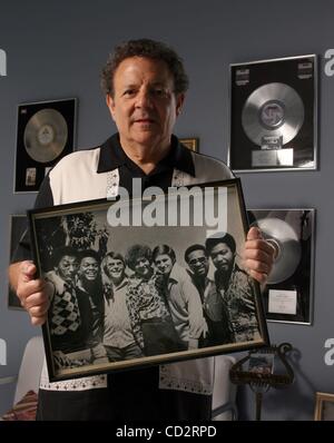 Mar 19, 2008 - Boca Raton, Florida, USA - Songwriter DENNIS LAMBERT in his home, Wednesday. Here he holds a photo of himself and the Four Tops and 2 others, (3rd from left) Brian Potter and (5th from right) Steve Barri (cq). (Credit Image: Â© Bob Shanley/Palm Beach Post/ZUMA Press) RESTRICTIONS: * U Stock Photo