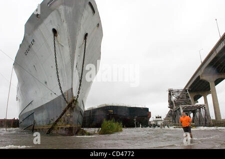 Mark Theard with the Orleans Levee District examines a large ship and a barge which came loose from their moorings in Inner Harbor Navigation Canal, or Industrial Canal, as Hurricane Gustav swept through New Orleans, Louisiana, USA on 01 September 2008. The vessels came to rest against a railroad br Stock Photo