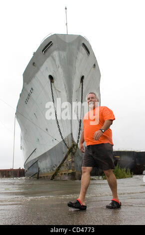 Mark Theard with the Orleans Levee District walks past a large ship and a barge which came loose from their moorings in Inner Harbor Navigation Canal, or Industrial Canal, as Hurricane Gustav swept through New Orleans, Louisiana, USA on 01 September 2008. The vessels came to rest against a railroad  Stock Photo