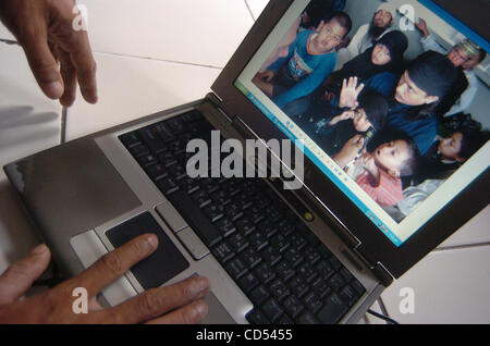 Nov 05, 2008 - Serang, Banten, Indonesia - Relative of Bali bomber Imam Samudra shows a photo of Samudra, center right, with Family. Three Indonesian militants on death row for the 2002 Bali bombings have exhausted legal options and cannot prevent their executions, a Supreme Court judge said. (Credi Stock Photo