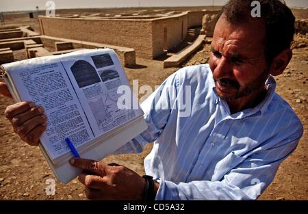 Mar 01, 2008 - Tallil, Iraq - Curator DIEF MOHSSEIN NAIIF AL-GIZZY points to a bible passage about Abraham in front of what some believe to be Abraham's house near the Ziggurat of Ur. Al-Gizzy is the third generation in his family to care for the Ziggurat and the surrounding ruins.  On the outskirts Stock Photo