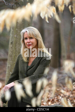 BONNIE MCENEANEY, author of 'Messages: Signs, Visits and Premonitions from Loved Ones Lost on 9/11'  at her home in New Canaan, Connecticut. She sits on a stone wall built by her late husband Eamon, who worked at Cantor Fitzgerald on the 105th floor of the North Tower and died in the attacks on the  Stock Photo