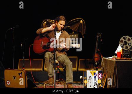 Pearl Jam frontman Eddie Vedder tries on a Chicago Cubs jersey as the Cubs  play host to the San Francisco Giants at Wrigley Field in Chicago,  Illinois, on June 30, 2011. (Photo