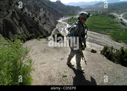 May 02, 2008 - Paktya Province, Afghanistan - A soldier climbs hillside with his platoon of the 101st Abn. patrolling the mountain ridgelines along a fertile valley in eastern Afghanistan, looking for observation and rocket-launching sites used by the Anti-Coalition Militia (ACM).  Charlie Company,  Stock Photo