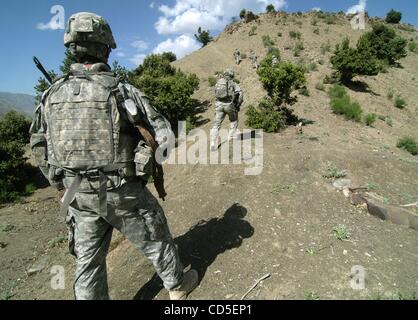 May 02, 2008 - Paktya Province, Afghanistan - A soldier climbs hillside with his platoon of the 101st Abn. patrolling the mountain ridgelines along a fertile valley in eastern Afghanistan, looking for observation and rocket-launching sites used by the Anti-Coalition Militia (ACM).  Charlie Company,  Stock Photo