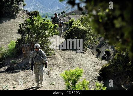 May 02, 2008 - Paktya Province, Afghanistan - A soldier climbs hillside with his platoon of the 101st Abn. patrolling the mountain ridgelines along a fertile valley in eastern Afghanistan, looking for observation and rocket-launching sites used by the Anti-Coalition Militia (ACM).  Charlie Company,  Stock Photo