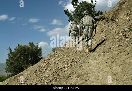 May 02, 2008 - Paktya Province, Afghanistan - A soldier climbs hillside with his platoon of the 101st Abn. patrolling the mountain ridgelines along a fertile valley in eastern Afghanistan, looking for observation and rocket-launching sites used by the Anti-Coalition Militia (ACM).  Charlie Company,  Stock Photo