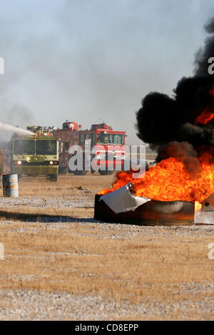 Oct 28, 2008 - Topeka, Kansas, USA - Metropolitan Topeka Airport Authority fire trucks douse the fire of a simulated airplane crash during a disaster drill at Forbes Field in Topeka, Kansas. Several Shawnee and Douglas county emergency agencies conducted the disaster exercise at Forbes Field to trai Stock Photo