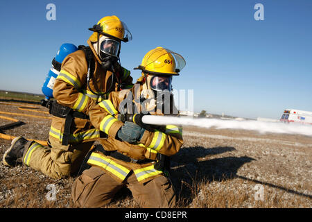 Oct 28, 2008 - Topeka, Kansas, USA - Metropolitan Topeka Airport Authority firefighters douse the fire of a simulated airplane crash during a disaster drill at Forbes Field in Topeka, Kansas. Several Shawnee and Douglas county emergency agencies conducted the disaster exercise at Forbes Field to tra Stock Photo