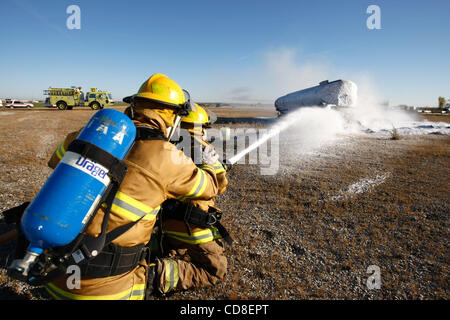 Oct 28, 2008 - Topeka, Kansas, USA - Metropolitan Topeka Airport Authority firefighters spray foam to put out a simulated fire and crash of an airplane during a disaster drill at Forbes Field in Topeka, Kansas. Several Shawnee and Douglas county emergency agencies conducted the disaster exercise at  Stock Photo