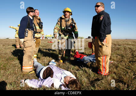 Oct 28, 2008 - Topeka, Kansas, USA - Firefighters stand over mock patients during a disaster drill at Forbes Field in Topeka, Kansas. Several Shawnee and Douglas county emergency agencies conducted the disaster exercise at Forbes Field to train with Department of Homeland Security purchased equipmen Stock Photo