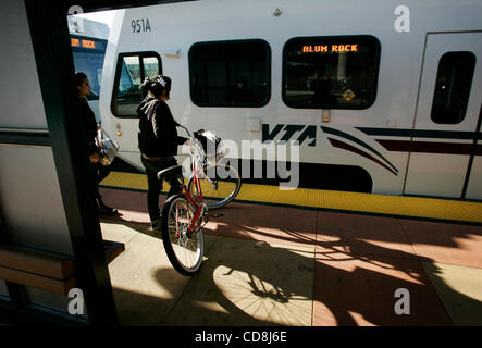 Passengers wait to board light rail at the Santa Teresa Blvd. train station in San Jose Wednesday Nov. 12, 2008.  Riders lugging bags, the disabled, parents hauling kids in strollers and bicycle users now have an easier way of getting on light rail. All 62 stations now offer level boarding, meaning  Stock Photo