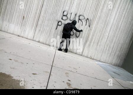 Jun 26, 2010 - Toronto, Ontario, Canada - An anarchist draws graffiti on a wall during the chaos downtown due to G20.  The G20 Summit is being held from June 26-27. Protesters flocked to the streets. (Credit Image: Â© Kamal Sellehuddin/ZUMApress.com) Stock Photo