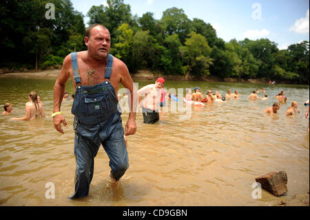 SATURDAY JULY 10, 2010 EAST DUBLIN, GEORGIA -A drunk Redneck Games participant  exits the river at Buckeye Park during the Redneck Games in East Dublin, Georgia. The games started in 1996 as spoof on the Olympics which were being held in Atlanta, Georgia at the time. participants compete in events l Stock Photo