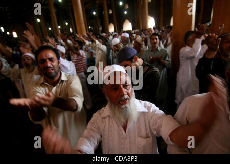 kashmir muslims Worshippers raise arms  inside Kashmir's Jamia Masjid before an anti-India protest march  in srinagar, the summer capital of Indian Kashmir on Friday, Aug. 13, 2010. Tens of thousands of Kashmir’s staged angry street demonstrations Friday after government forces killed four people an Stock Photo