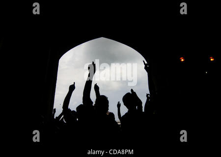 kashmir muslims Worshippers raise arms while shouting anti-India slogans inside Kashmir's Jamia Masjid before an anti-India protest march in srinagar,  the summer capital of Indian Kashmir on Friday, Aug. 13, 2010. Tens of thousands of Kashmir’s staged angry street demonstrations Friday after govern Stock Photo