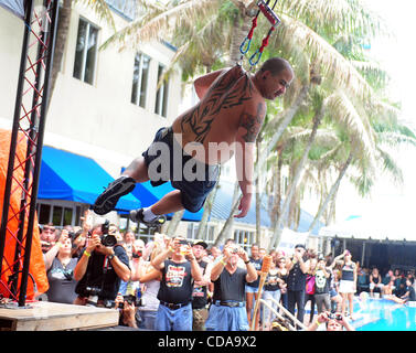 Aug. 15, 2010 - Deerfield Beach, FL - Florida, USA - United States - (CAV) TATTOO 0815L.CAV ''Chong,'' of the performance group ''Skin Madness,'' hangs from piercings in his back, during the 15th Annual South Florida Tattoo Expo, Sunday, Aug. 15, at the Hilton in Deerfield Beach.  Joe Cavaretta, Sun Stock Photo