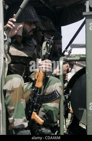 An indian army soldisrs petroling  during a curfew in  Srinagar,the summer capital of indian kashmir  on ,Thursday, Sept. 16, 2010. The recent eruption of violence in the Kashmir valley has left the government searching for a new strategy for dealing with months of kashmiri separatist protests, and  Stock Photo