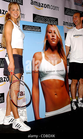 K32368AR.ANNA KOURNIKOVA AND JEFF BEZOS (OF AMAZON.COM) .INTRODUCE ANNA'S NEW SPORTS BRA, .''SHOCK ABSORBER''.AT TENNIS MAGAZINE'S GRAND SLAM; .AN ALL DAY TENNIS FESTIVAL .HELD IN GRAND CENTRAL TERMINAL'S VANDERBILT HALL IN NEW YORK New York. .8/22/2003. / 2003(Credit Image: © Andrea Renault