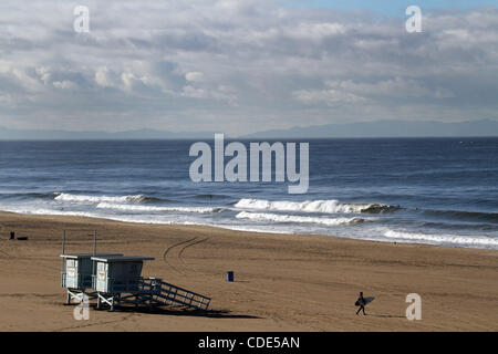 Feb. 20, 2011 - Los Angeles, California, U.S - A surfer heads out to the waves in Playa Del Rey as a cold winter storm moves out of the Southern California area on Sunday, February 20, 2011. (Credit Image: © Jonathan Alcorn/ZUMAPRESS.com) Stock Photo