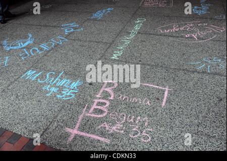Mar. 23, 2011 - Manhattan, New York, U.S. - Fashion Institute of Technology students create a sidewalk of remembrance as they write the names of the 146 factory workers who died in the Triangle Shirtwaist Factory in chalk on the sidewalk in commemoration of the 100th anniversary of the fire. (Credit Stock Photo