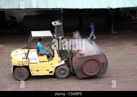 Mar 25, 2011 - Isulan, Mindanao Island, Philippines - Filipino workers at the processing plant for oil palm fruits. Palm oil is considered as important as its other resources as it aims for growth. Asian firms like those in Indonesia and Philippines might take the lead in the production of palm oil  Stock Photo