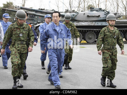 Apr. 2, 2011 - Narahar, Japan - In this photo released by Prime Minister's Office of Japan, Japanese Prime Minister Naoto Kan, dressed in the blue work clothes, walks with members of the Japan Ground Self-Defense Force during his visit to J-Village, a national training center at Naraha town, Fukushi Stock Photo