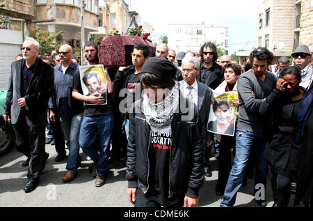 People carry the coffin of Arab-Israeli actor and director Juliano Mer Khamis during a funeral procession near al-Midan theater in the northern Israeli city of Haifa April 6, 2011. Mer-Khamis was gunned down Monday in the West Bank town where he ran a drama school and community theater, and was laid Stock Photo
