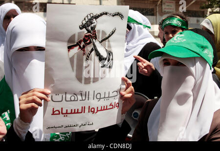 Palestinian women supporters of the Hamas Islamist movement take part in a rally calling for the release of Palestinians being held in West Bank and Gaza Strip jails in the West Bank city of Hebron on May 10, 2011. Photo by Najeh Hashlamoun Stock Photo