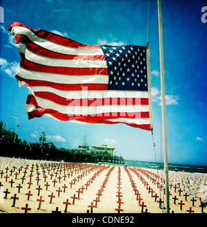 May 29, 2011 - Santa Monica, California, U.S - Am American flag flies in the wind at the ''Arlington West'' Memorial on Sunday, May 29, 2011.  Small wooden crosses, one for each U.S. military member who has died in either Iraq or Afghanistan, are placed in the sand on Santa Monica Beach bach Sunday  Stock Photo