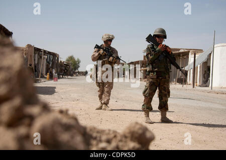 Apr 27, 2011 - Town of Naw Zad, Naw Zad district, Helmand, Afghanistan - An ANA soldier from 4th Company, 3rd Kandak, 2nd Brigade of 215th Afghan National Army Corps secures the area during a joint patrol with Marines of Lima Company, 3rd Battalion of 2nd Marine Regiment in the Bazar of Naw Zad in N Stock Photo