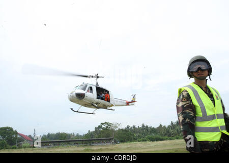 Apr 23, 2011 - Pantukan, Compostella Valley, Philippines - A chopper airlifting reporters and rescuers to search for people missing Saturday, after an avalanche of mud buried an illegal gold mining camp on Friday, April 22, 2011 is seen at the town proper of Pantukan in Compostella Valley in the sou Stock Photo