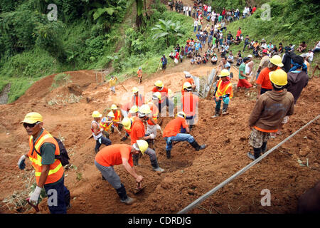 Apr 23, 2011 - Pantukan, Compostella Valley, Philippines - Rescuers search for missing people Saturday after an avalanche of mud buried an illegal gold mining camp on Friday. Officials say at least three bodies have been recovered so far and 15 have been rescued, while 21 people are still missing. ( Stock Photo