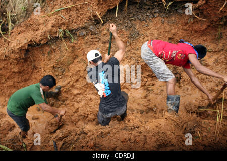 Apr 23, 2011 - Pantukan, Compostella Valley, Philippines - Rescuers search for missing people Saturday after an avalanche of mud buried an illegal gold mining camp on Friday, April 22, 2011 in the town of Pantukan in Compostella Valley in the southern Philippines. Officials say at least three bodies Stock Photo