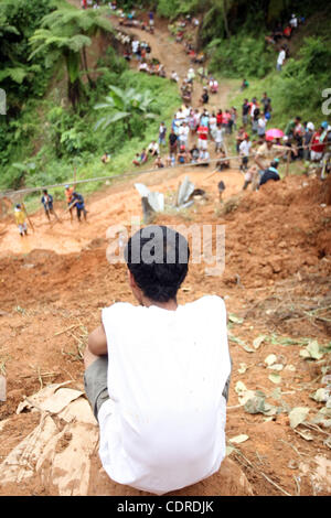 Apr 23, 2011 - Pantukan, Compostella Valley, Philippines - A resident is seen at the landslide site where rescuers search for people missing Saturday after an avalanche of mud buried an illegal gold mining camp on Friday, April 22, 2011 in the town of Pantukan in Compostella Valley in the southern P Stock Photo